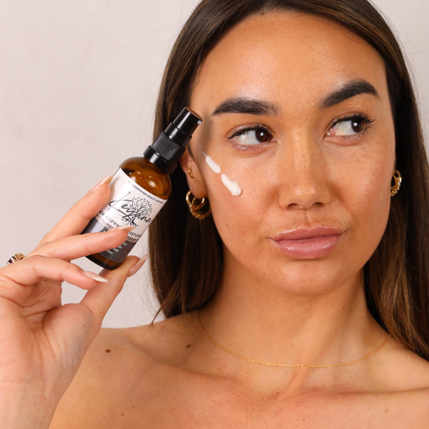 Model applying Keyana Age-Defying Moisturiser – rejuvenating cream that deeply hydrates and reduces the appearance of fine lines and wrinkles.