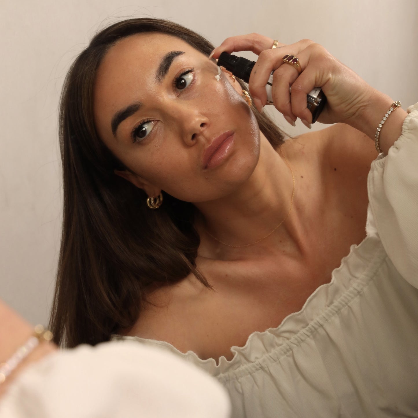 Model applying Keyana Balancing Moisturiser – non-greasy moisturiser that nourishes and controls oil, leaving skin hydrated, balanced, and fresh.